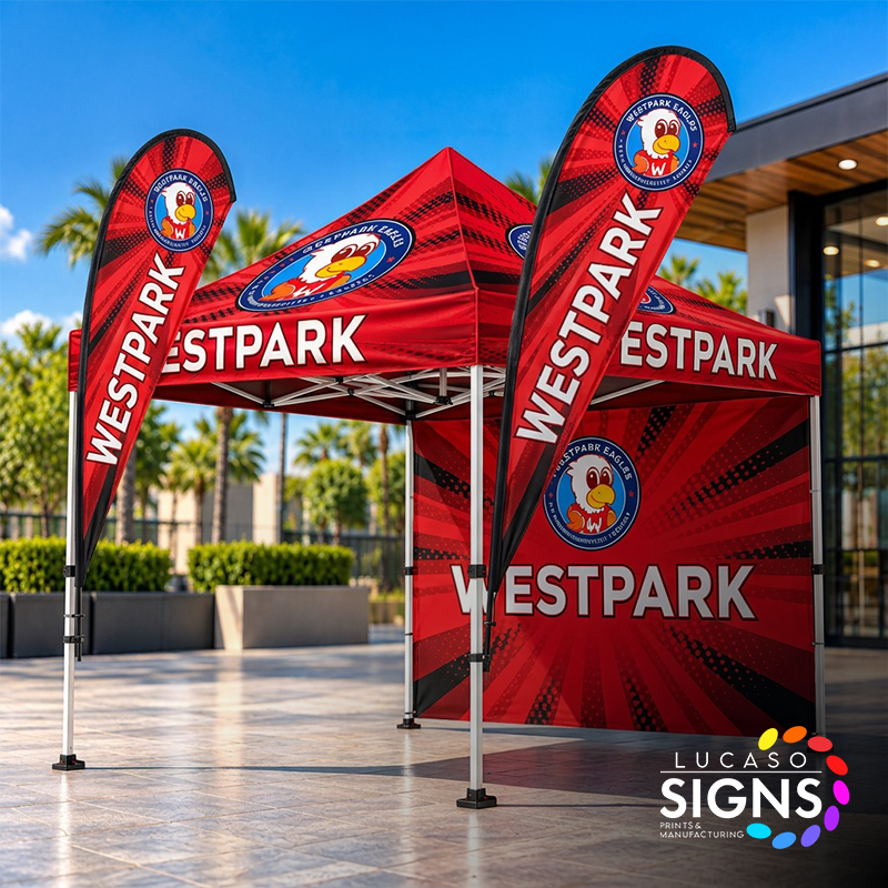 Custom red promotional canopy tent with printed roof, branded sidewalls, and matching teardrop flags for outdoor events and business advertising.